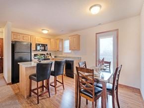 Triadelphia apartment for rent - a kitchen with a breakfast bar and a table with chairs