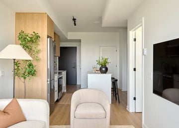 Ottawa apartment for rent - A living room with a white couch and a lamp.