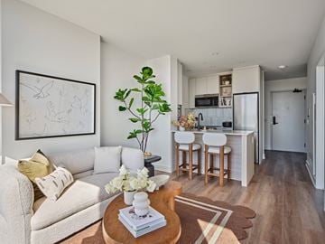 Ottawa apartment for rent - A living room with a couch, a coffee table, and a painting on the wall.