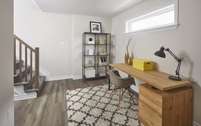 Ottawa townhouse for rent - a home office with a wooden desk and chair in a room with a staircase