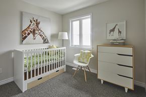 Ottawa townhouse for rent - a nursery with a crib with a giraffe painting on the wall and a chair