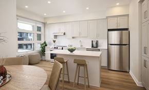 Kanata townhouse for rent - a kitchen and dining area with a white counter top and a stainless steel refrigerator