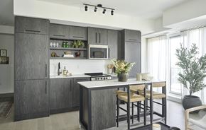 Ottawa apartment for rent - a kitchen with an island and stools in a house