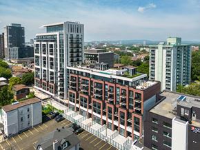 Ottawa apartment for rent - an aerial view of a large building in a city with tall buildings
