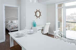 Ottawa apartment for rent - a dining room with a white table and chairs and a bedroom with a bed