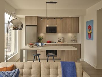 Toronto apartment for rent - A modern kitchen with a dining area and a living room.