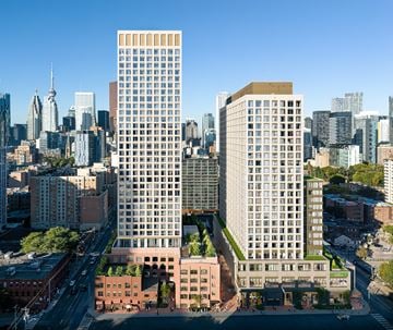 Toronto apartment for rent - A cityscape with a mix of modern and older buildings, with a clear blue sky above.