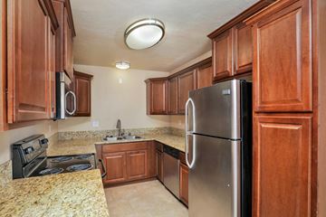 La Mesa apartment for rent - a kitchen with stainless steel appliances and wooden cabinets