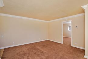 La Mesa apartment for rent - an empty living room with carpet and a door to a bedroom