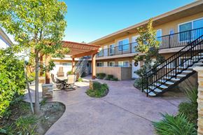 La Mesa apartment for rent - a patio with a staircase and trees in front of a building