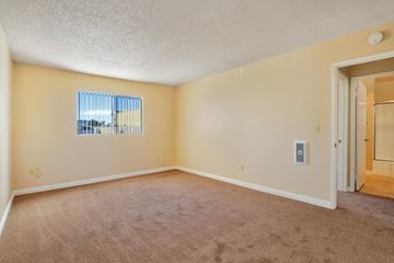 Santee apartment for rent - a living room with carpet and a door to a hallway