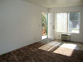 El Cajon apartment for rent - an empty living room with a heater and a door to a patio