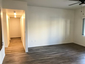El Cajon apartment for rent - an empty living room with a wood floor and a ceiling fan