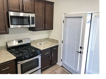 El Cajon apartment for rent - a kitchen with a stove and a microwave and a refrigerator