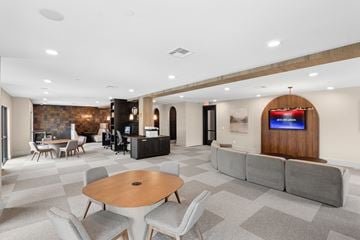 Houston apartment for rent - A modern living room with a wooden table and grey sofa.