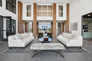 Longmont apartment for rent - A modern living room with a white sofa set and a coffee table in the center.