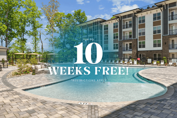 Charlotte apartment for rent - A pool surrounded by a building with a sign that says 10 weeks free.