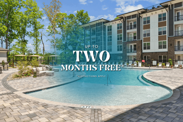 Charlotte apartment for rent - A swimming pool in front of a building with the text "UP TO TWO MONTHS FREE" on it.