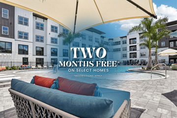 Fort Myers apartment for rent - A poolside lounge chair with a cushion and a white umbrella.