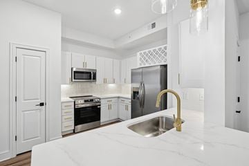 Bonita Springs apartment for rent - A modern kitchen with a marble countertop and stainless steel appliances.