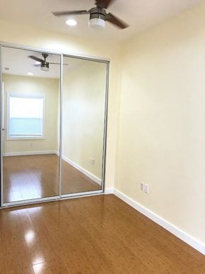 Los Angeles apartment for rent - A room with a ceiling fan and sliding glass doors.