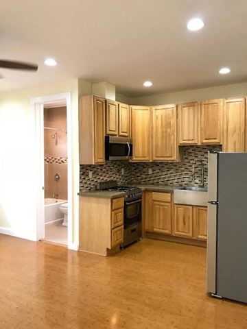 Los Angeles apartment for rent - A kitchen with wooden cabinets and a refrigerator.