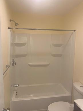 Compton apartment for rent - A white toilet is in a small bathroom with a walk-in shower.