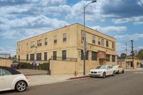 Los Angeles apartment for rent - A white car is parked in front of a building with a sign that reads "SALON".