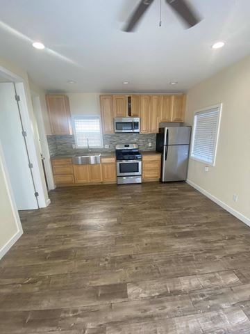Los Angeles apartment for rent - A kitchen with wooden cabinets and a black fridge.