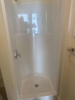 Los Angeles apartment for rent - A white shower stall with a drain in the bottom.