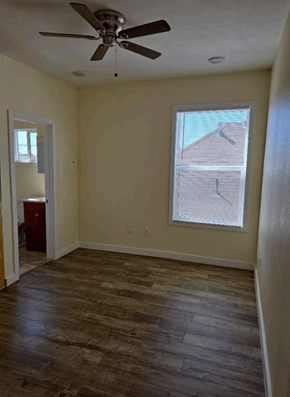 Los Angeles apartment for rent - A room with a ceiling fan and a window with blinds.