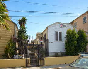 Los Angeles apartment for rent - A white house with a red and blue sign on the front.