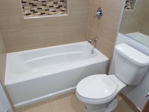 Los Angeles apartment for rent - A white toilet sits next to a bathtub in a bathroom.