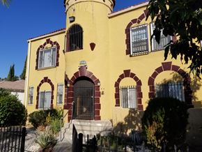 Los Angeles apartment for rent - A yellow house with a black gate in front.