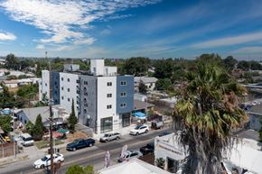 Los Angeles apartment for rent - an aerial view of a white building and a palm tree