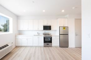 Los Angeles apartment for rent - a kitchen with white cabinets and a stainless steel refrigerator