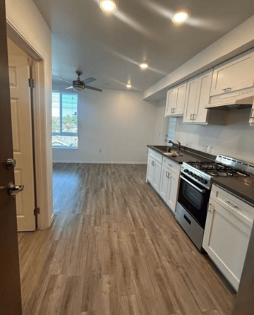 Los Angeles apartment for rent - A kitchen with white cabinets and a wooden floor.