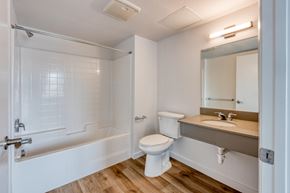 San Diego apartment for rent - A white bathroom with a toilet, sink, and bathtub.