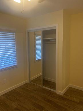 Compton apartment for rent - A room with a door and a window with blinds.