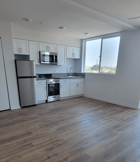 Los Angeles apartment for rent - A kitchen with wooden floors and stainless steel appliances.