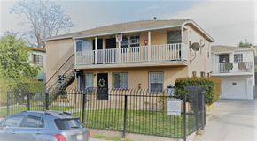 Los Angeles apartment for rent - A car is parked in front of a two-story apartment building with a black fence.
