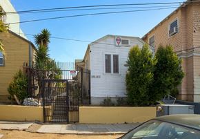 Los Angeles apartment for rent - A white house with a red and white sign on the front.