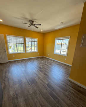 Los Angeles apartment for rent - A room with yellow walls and a ceiling fan.