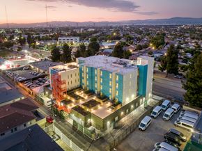 Los Angeles apartment for rent - A multi-story building with a parking lot in front of it.