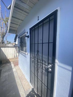 Los Angeles apartment for rent - A white wall with a black gate and a number 1 on it.