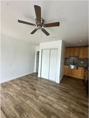 Los Angeles apartment for rent - A room with a ceiling fan and wooden flooring.