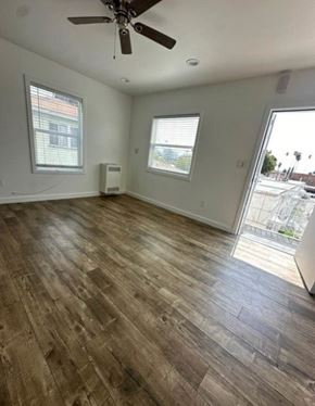 Los Angeles apartment for rent - A room with a ceiling fan and wood flooring.