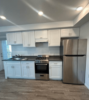 Los Angeles apartment for rent - A kitchen with white cabinets and a stainless steel refrigerator.