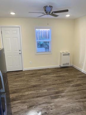 Long Beach apartment for rent - A room with a ceiling fan and a window with blinds.