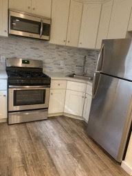 Los Angeles apartment for rent - A kitchen with a stainless steel refrigerator, oven, and microwave.